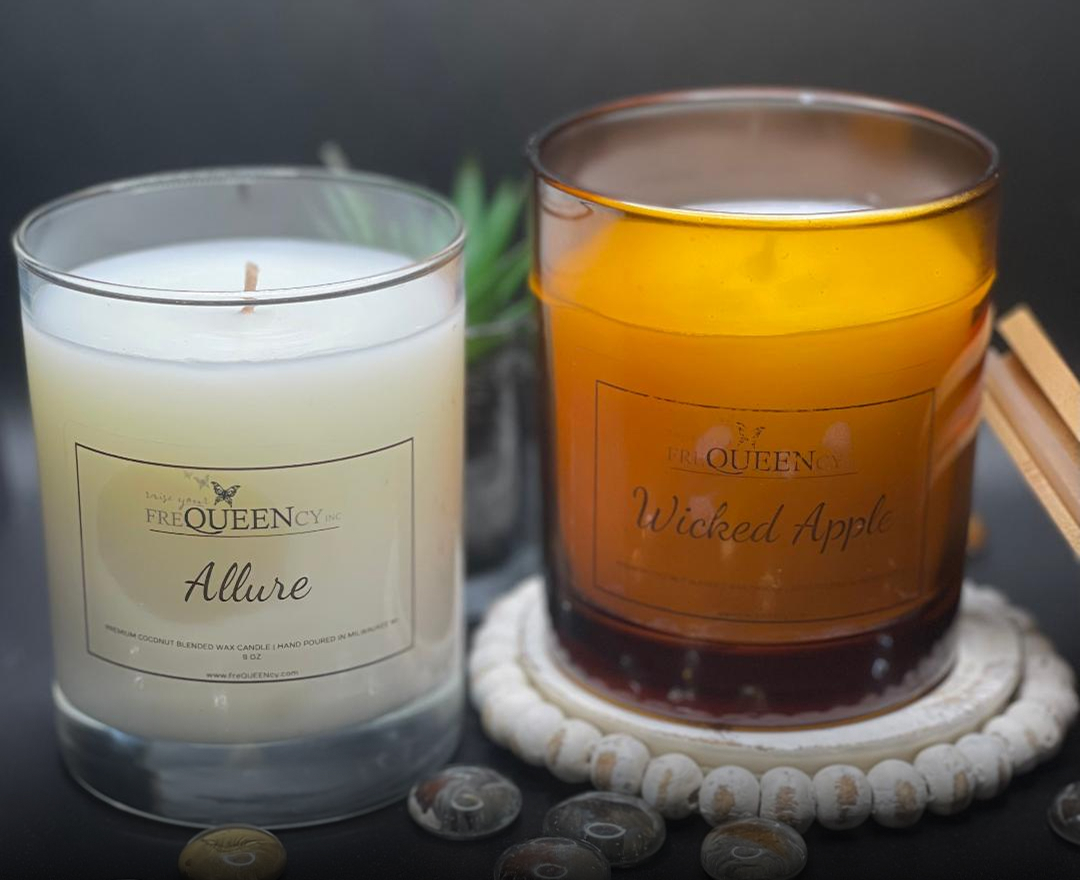 Two candles in varying colors and scents, one a calming blue and the other a vibrant red, placed side by side.